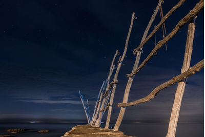 Low angle view of rope against sky at night