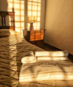 Electric lamp on bed by wall at home