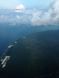 Aerial view of sea and cityscape against sky