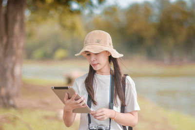 Young woman using mobile phone outdoors