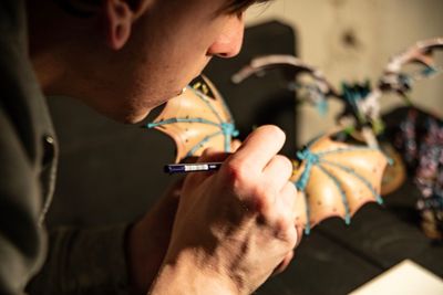 High angle view of man making decorating equipment in halloween