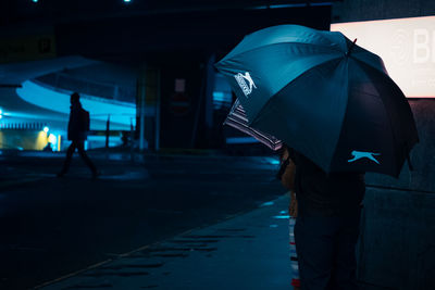 Man walking on footpath in city