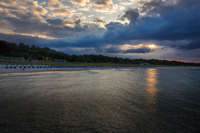 Scenic view of beach against sky during sunset