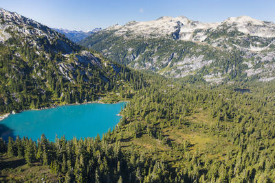 Aerial view of turquoise lake in a mountain setting.