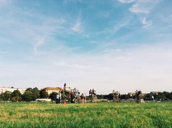 People walking on grassy field