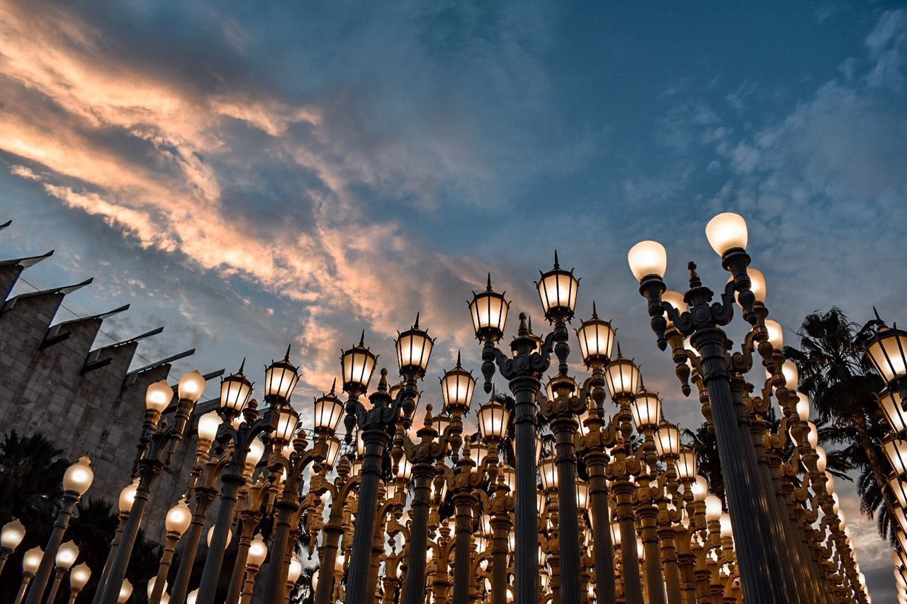 LOW ANGLE VIEW OF ILLUMINATED STREET LIGHTS AT NIGHT