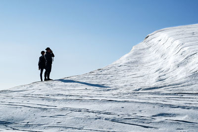 People on snow covered landscape