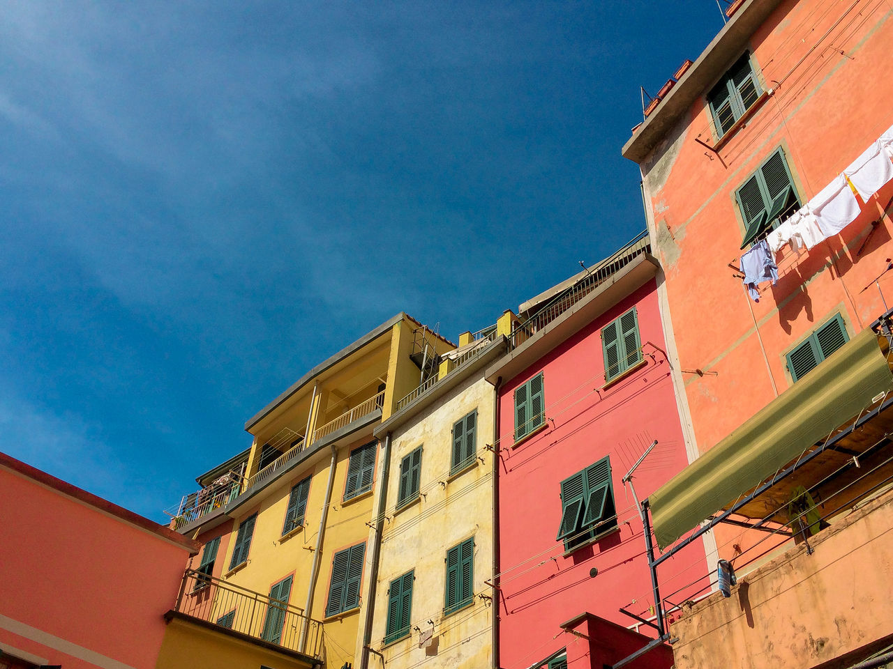 LOW ANGLE VIEW OF MULTI COLORED BUILDINGS IN TOWN