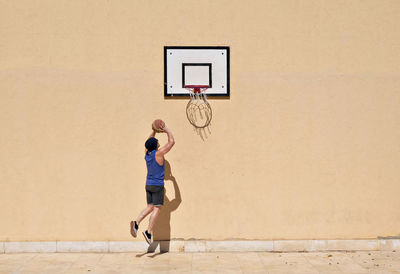 Man playing basketball outdoors