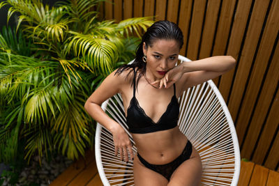 Young woman sitting on hammock