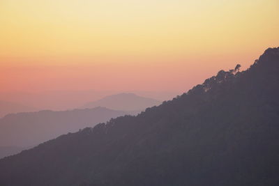 Scenic view of silhouette mountains against sky during sunset