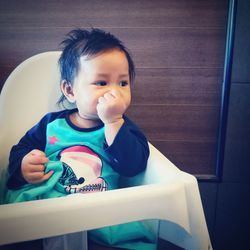 Portrait of cute boy looking at home