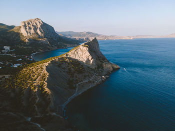 High angle view of rocks on sea shore against sky