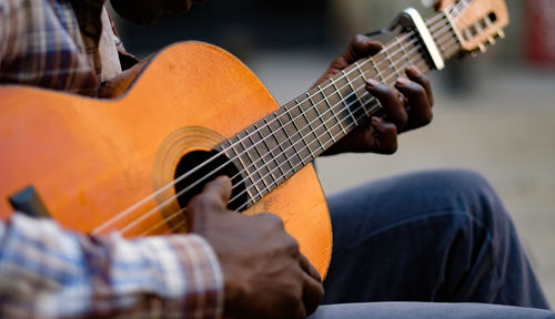 Close-up of man playing guitar