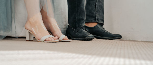 Low section of couple standing on floor