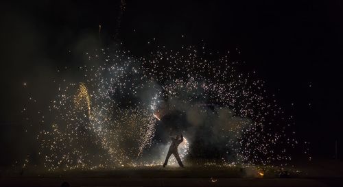 Man with sparks at night