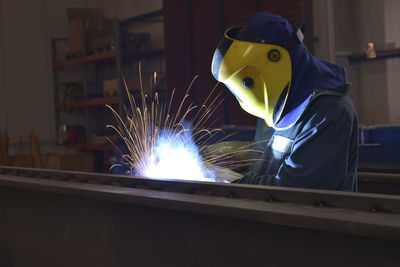 Welder at work in factory