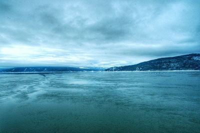 Scenic view of sea against cloudy sky