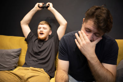 Portrait of a young man sitting on sofa