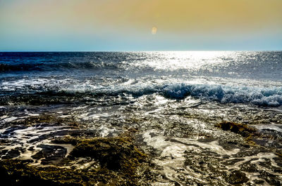 Scenic view of sea against clear sky during sunset