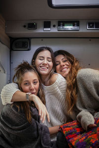 Happy friends spending leisure time in motor home