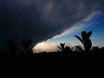 Silhouette of landscape against cloudy sky