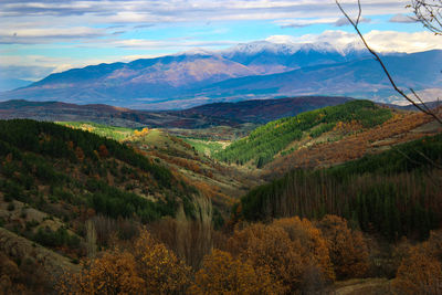 Scenic view of mountains against cloudy sky