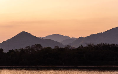 Scenic view of silhouette mountains against sky during sunset