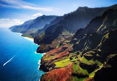 Scenic view of sea and mountains against sky