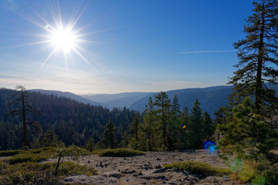 Scenic view of mountains against bright sun