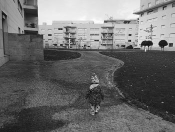 Man on street against buildings in city