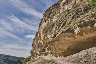 Low angle view of rock formations against sky