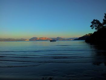 Scenic view of calm sea against clear sky