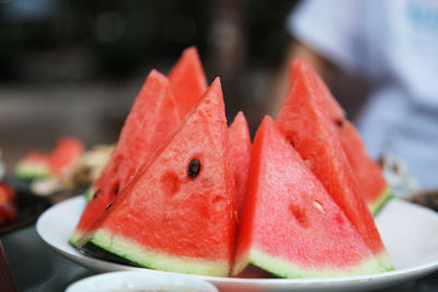 Close-up of chopped fruit in plate on table