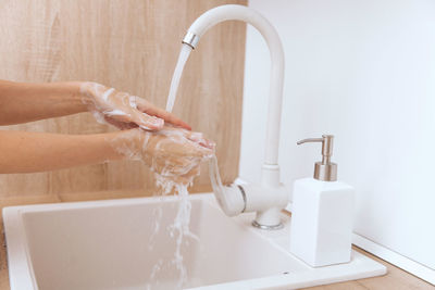 Cropped hand washing hands