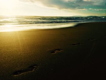 Scenic view of beach against sky during sunset