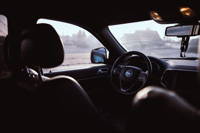 View of car on road seen through windshield