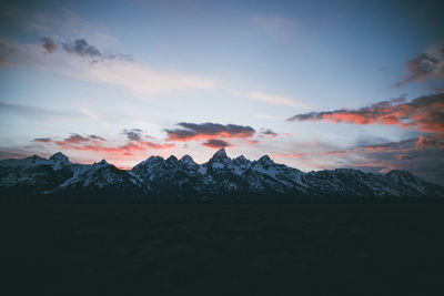 Scenic view of snowcapped mountains against sky during sunset