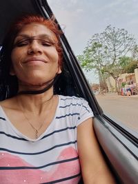 Portrait of woman sitting outdoors