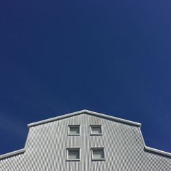 Low angle view of building against blue sky