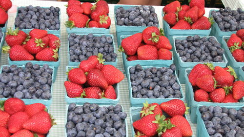 High angle view of strawberries and blueberries at market stall