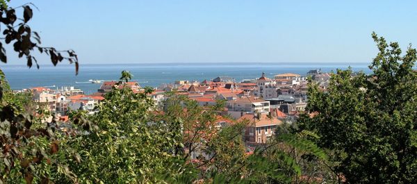 View of town by sea against clear sky