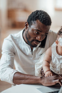 Portrait of mother with baby sitting