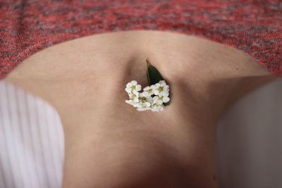 Close-up of woman with flower on neck