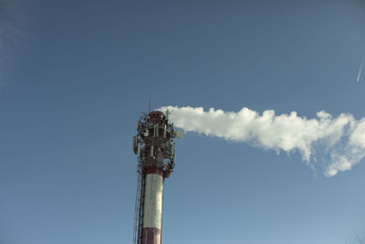 Chimney with smoke. boiler station. industrial pipe on sky. factory details.