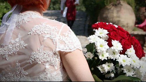 Close-up of woman holding flowers