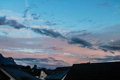 Houses against sky during sunset