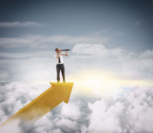 Low angle view of woman standing against sky