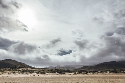 Scenic view of mountains against cloudy sky
