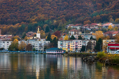 Buildings at waterfront during autumn
